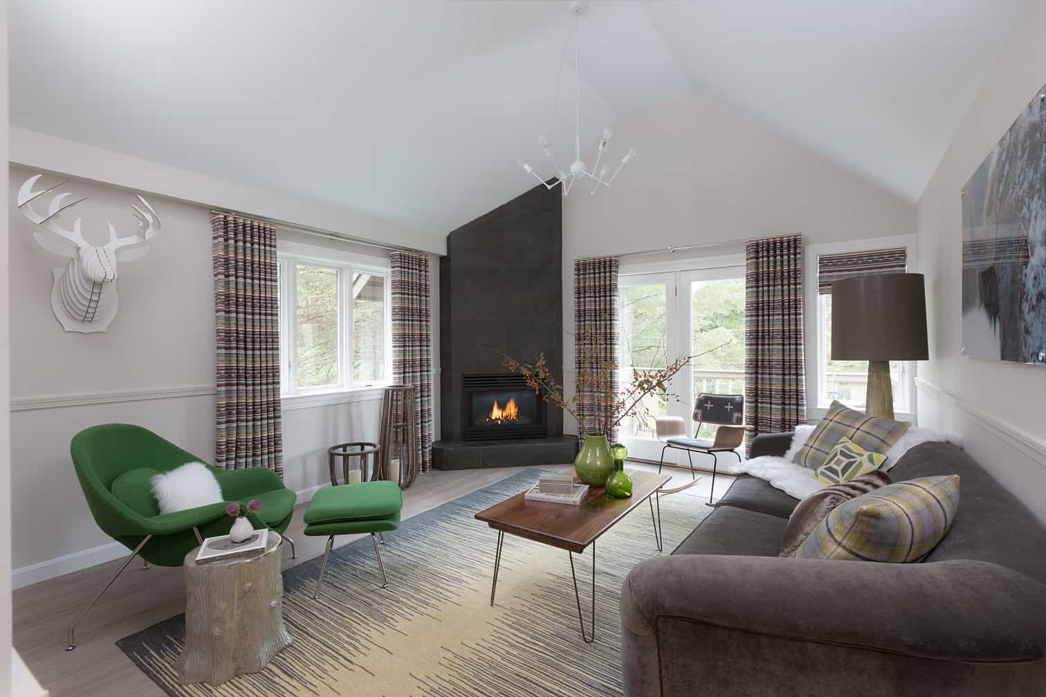 Field Guide Lodge Stowe - Living Room with Fireplace and Green Chair