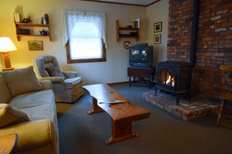 Stowe Cabins in the Woods - Living Room with Wood Stove and TV
