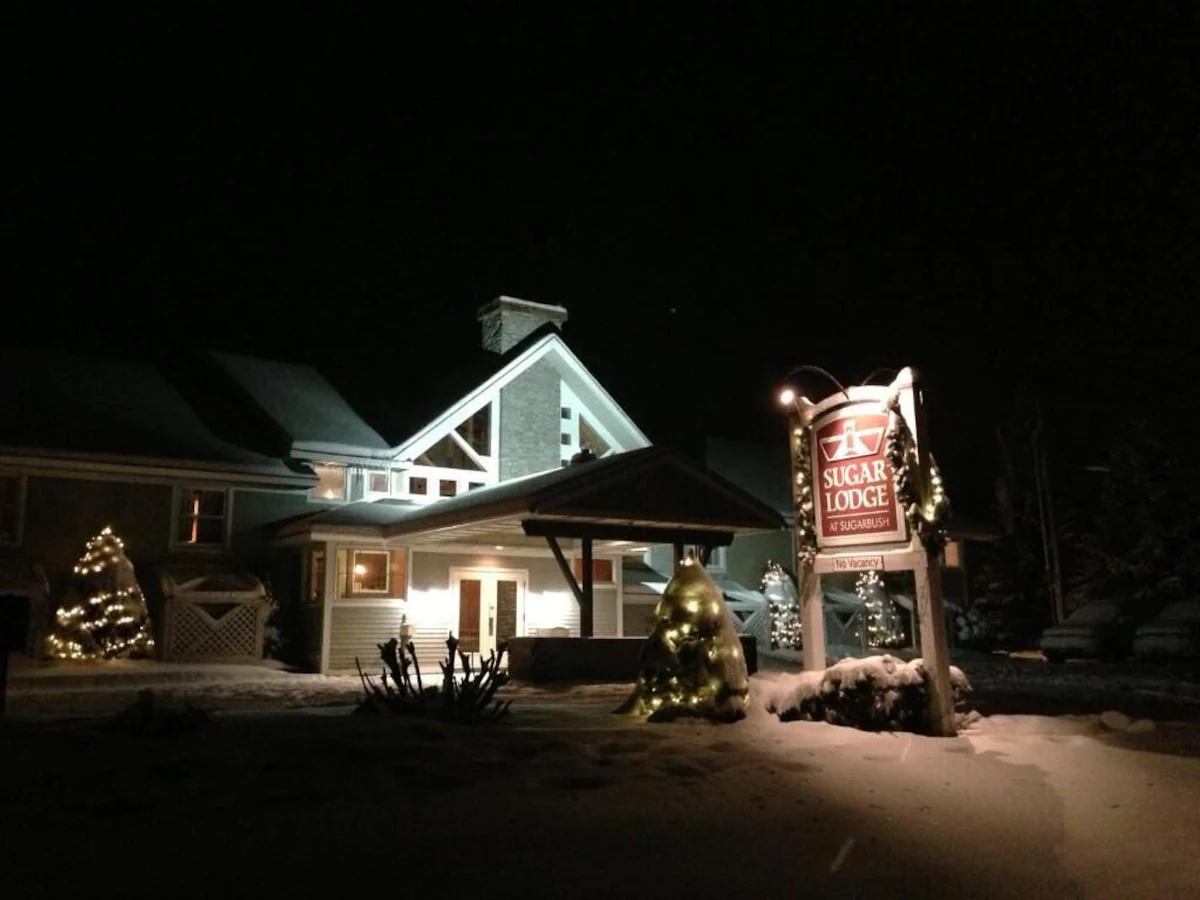 Sugar Lodge at Sugarbush - Winter Exterior Entrance with Sign at Night