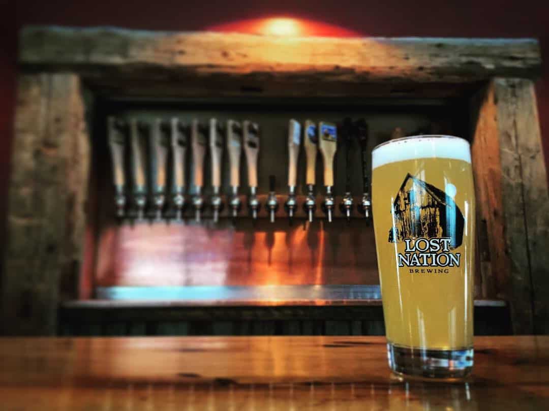Lost Nation Brewing Pint on Bar with Tap Handles in Back
